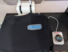 Schwarzes T-Shirt mit aufliegendem BASIC-TUTORIALS-Transfer vor dem Pressvorgang